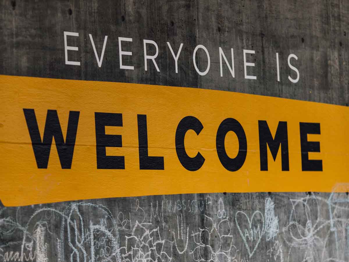 Words on a wall reading everyone is welcome