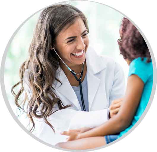 Smiling female provider using a stethoscope to listen to a child's heartbeat.