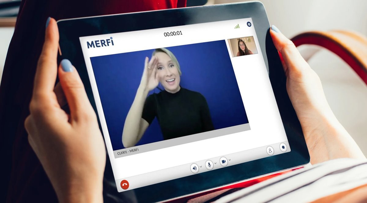 An agent speaks with their client and an ASL interpreter on Merfi, CLI's video interpreting platform.