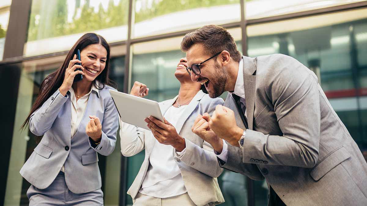 Three businesspeople celebrate CLI’s technology upgrade to NICE.