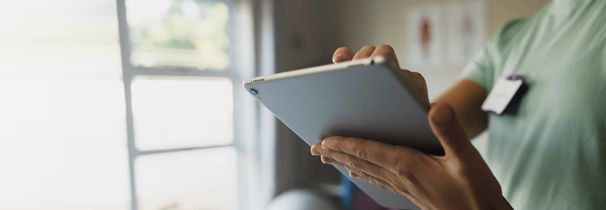 An IT implementation specialist scrolls through Merfi integration specs on their tablet.