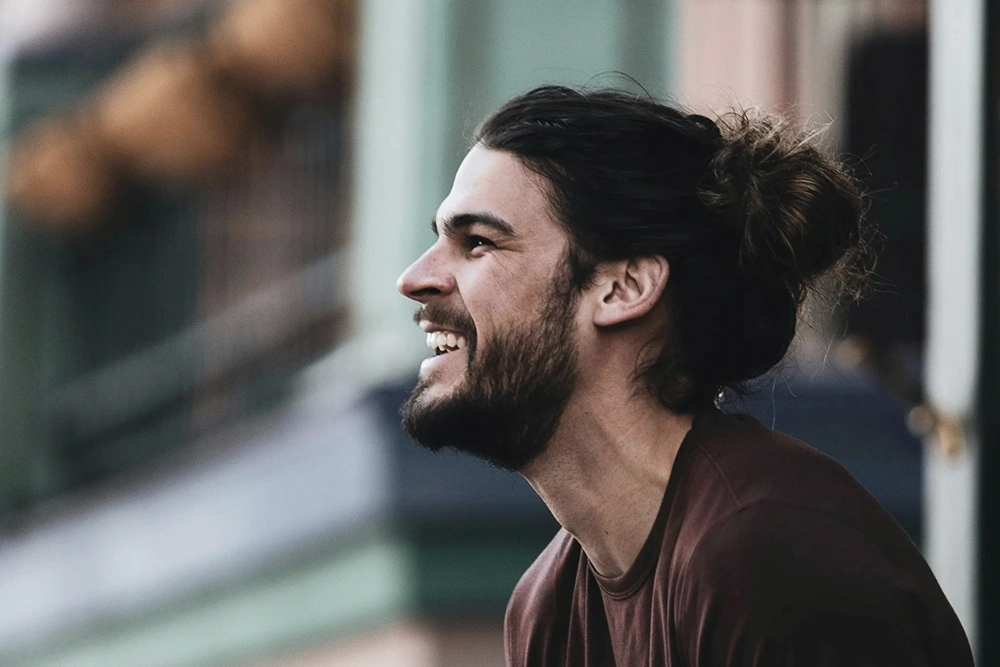 A satisfied non-English speaking customer grins after getting off the phone with interpreter services.